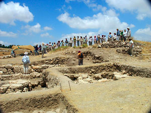 David Hopkins (standing left center), Field Supervisor of Field L, indicating new areas of excavation