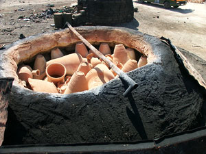 A kiln full of fired vessels prior to removal