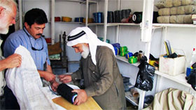 Mohamad the tent-maker in Madaba including thread and needle, with Doug Clark and Romel Gharib