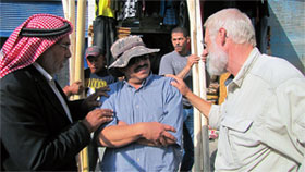 Truck driver, Romel Gharib, Doug Clark with Abu Issa and Osama holding tent poles