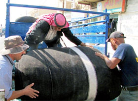 Rolling the main portion of the tent onto delivery truck